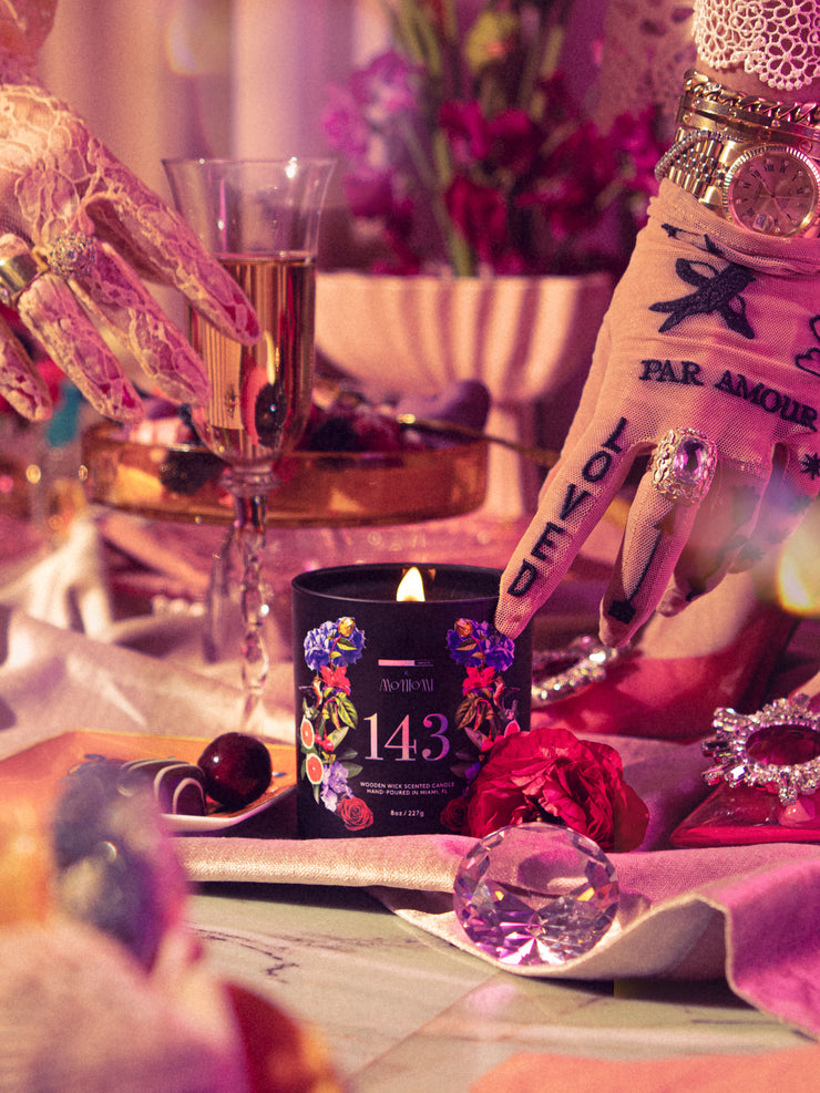 Lit 143 Candle on Opulent and Eclectic Tablescape with Hand Touching 